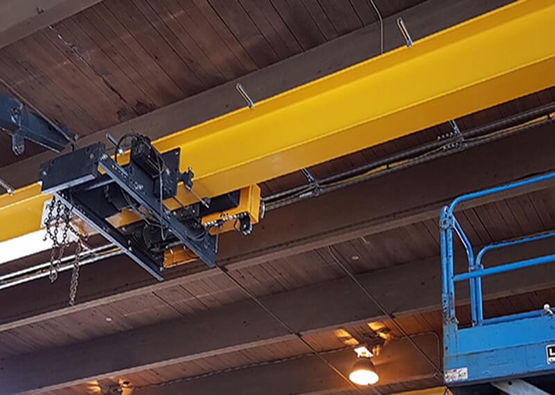 What caused the single girder overhead crane to hit the top?